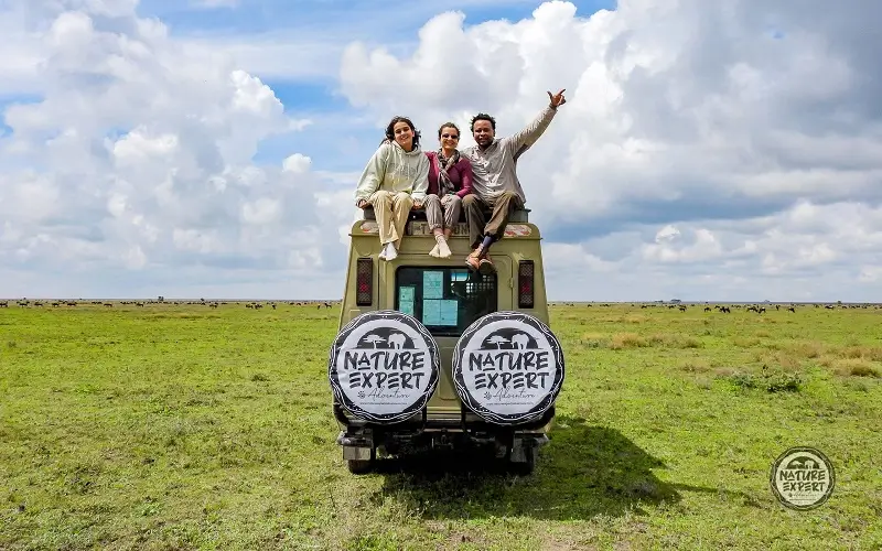 african-safari-travelers-savanna-jeep-Tanzania